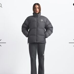 Authentic BNWT Skims X TNF 1996 Nuptse Jacket in Gunmetal. Size women’s Large.